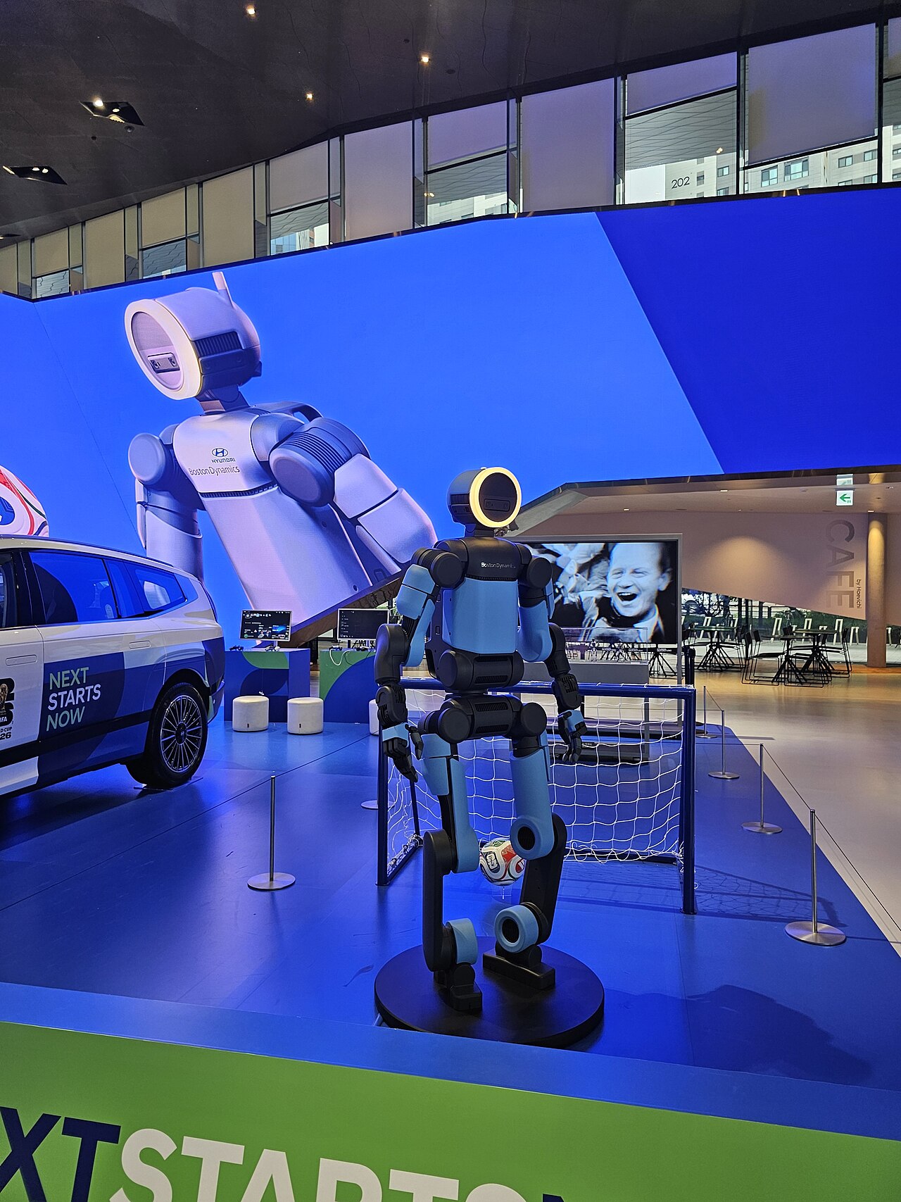 Boston Dynamics electric Atlas humanoid robot on display in front of a small soccer goal